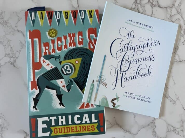 covers of pricing and ethical guidelines and the calligraphers business handbook spread out on a table