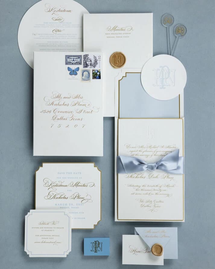 white paper and gold calligraphy wedding suite with blue background