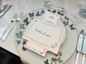 corporate handwriting for event, envelope on place setting with butterflies on plate