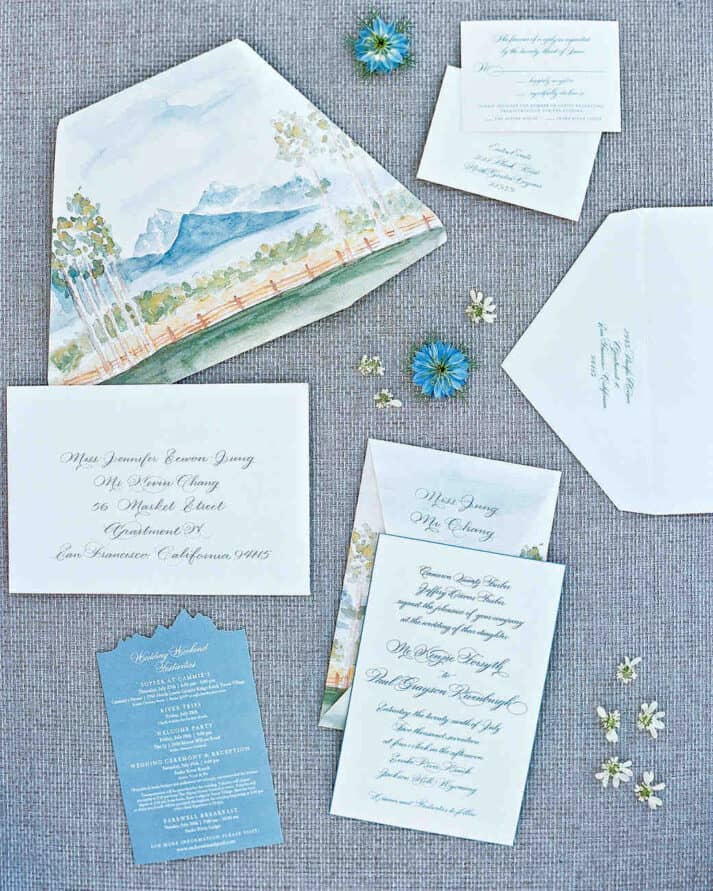 wedding invitation calligraphy with envelope and mountain motif